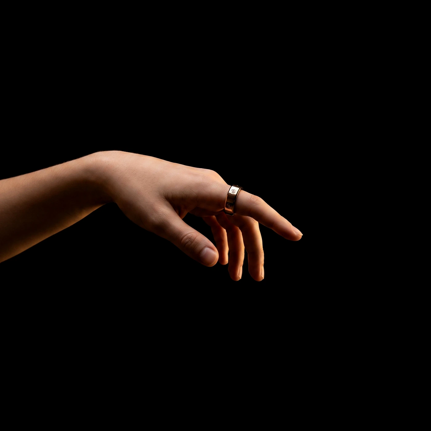 A younger hand wearing the LuxenX ring, reaching out